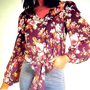 Beautiful floral blouse featuring v-neck, long balloon sleeves & bow tied waist